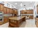 Large kitchen with stainless steel refrigerator, oversized granite island and custom cabinets at 9869 E Davenport Dr, Scottsdale, AZ 85260