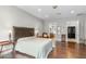 Elegant primary bedroom with hardwood floors, a tray ceiling, and ample space at 9869 E Davenport Dr, Scottsdale, AZ 85260