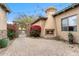 Cozy courtyard with a unique outdoor fireplace, desert landscaping, and a charming brick patio at 9869 E Davenport Dr, Scottsdale, AZ 85260