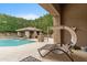 Relaxing patio area with comfortable chaise lounge and view of the pool and outdoor living space at 9869 E Davenport Dr, Scottsdale, AZ 85260