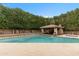 Beautiful in-ground pool features a swim-up bar area and lush landscaping for a private backyard retreat at 9869 E Davenport Dr, Scottsdale, AZ 85260