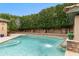 Beautiful pool with a waterfall feature, jacuzzi, and lush landscaping, perfect for relaxing and entertaining at 9869 E Davenport Dr, Scottsdale, AZ 85260