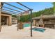 Outdoor living includes a pool, spa, covered bar with fireplace, and ample patio space, perfect for entertaining at 9869 E Davenport Dr, Scottsdale, AZ 85260