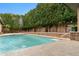 Private backyard pool with a waterfall feature and lush greenery providing a serene and secluded environment at 9869 E Davenport Dr, Scottsdale, AZ 85260