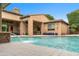 Refreshing pool view with a gentle waterfall feature and inviting outdoor seating, blending indoor and outdoor living at 9869 E Davenport Dr, Scottsdale, AZ 85260