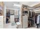 Spacious walk-in closet with custom shelving, drawers, and ample storage space for clothes and accessories at 9869 E Davenport Dr, Scottsdale, AZ 85260