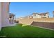 Expansive backyard featuring low maintenance turf, patio, and desert landscaping at 9923 E Texas Ave, Mesa, AZ 85212