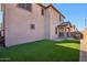 A lush backyard featuring a low maintenance turf area and a covered patio at 9923 E Texas Ave, Mesa, AZ 85212