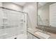 Clean bathroom featuring tiled shower with glass door, vanity with stone countertop, and modern fixtures at 9923 E Texas Ave, Mesa, AZ 85212