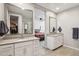 Bright bathroom featuring double vanities and a view into the primary bedroom at 9923 E Texas Ave, Mesa, AZ 85212