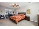 Comfortable bedroom featuring a ceiling fan, desk, and natural light from the window at 9923 E Texas Ave, Mesa, AZ 85212