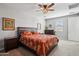 Inviting bedroom with a ceiling fan, large bed, and neutral colors at 9923 E Texas Ave, Mesa, AZ 85212