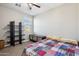 Comfortable bedroom featuring a colorful quilt, neutral walls, and dark shelving at 9923 E Texas Ave, Mesa, AZ 85212
