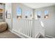 Bright hallway featuring three arched windows with great natural light and white railing at 9923 E Texas Ave, Mesa, AZ 85212