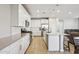 Modern kitchen with white cabinets, stainless steel appliances, tile backsplash, and large island at 9923 E Texas Ave, Mesa, AZ 85212