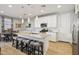 Modern kitchen with white cabinets, stainless steel appliances, a kitchen island, and counter seating at 9923 E Texas Ave, Mesa, AZ 85212