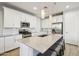 Bright kitchen with stainless steel appliances, large island, and stylish pendant lighting at 9923 E Texas Ave, Mesa, AZ 85212