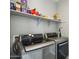 Well-organized laundry room with modern stainless steel washer and dryer, and shelving at 9923 E Texas Ave, Mesa, AZ 85212