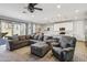 Bright living space with a plush sectional, modern lighting, and an open layout to the kitchen at 9923 E Texas Ave, Mesa, AZ 85212