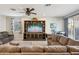 Comfortable living room features a large sectional, a ceiling fan, and a wooden entertainment center at 9923 E Texas Ave, Mesa, AZ 85212