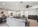 Open-concept living area with modern furnishings, flowing seamlessly into a bright, well-equipped kitchen at 9923 E Texas Ave, Mesa, AZ 85212