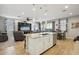 Open-concept living room featuring tile flooring, recessed lighting, and seamless flow into the kitchen area at 9923 E Texas Ave, Mesa, AZ 85212
