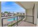 Balcony view overlooks community pool and lush landscaping on a bright sunny day at 1111 E Missouri Ave # 9, Phoenix, AZ 85014