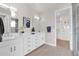 Bright bathroom with double sink vanity, modern fixtures, and a view into the walk-in closet at 1111 E Missouri Ave # 9, Phoenix, AZ 85014
