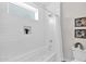 Bright white bathroom featuring a shower-tub combo, tiled walls, and modern finishes at 1111 E Missouri Ave # 9, Phoenix, AZ 85014
