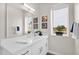Bathroom features dual sinks, white cabinetry, a large mirror, and decor at 1111 E Missouri Ave # 9, Phoenix, AZ 85014