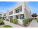 Modern two-story home featuring stucco and stacked stone facade with private balconies and manicured landscaping at 1111 E Missouri Ave # 9, Phoenix, AZ 85014