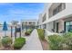 Exterior view of modern condo buildings with a community pool and walkway surrounded by manicured shrubs at 1111 E Missouri Ave # 9, Phoenix, AZ 85014