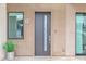 Contemporary front door with side window and number display, enhanced by modern design and landscaping at 1111 E Missouri Ave # 9, Phoenix, AZ 85014