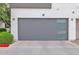 Garage of unit #9 with a modern door including translucent windowpanes and exterior lighting at 1111 E Missouri Ave # 9, Phoenix, AZ 85014