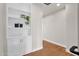 Hallway featuring wood floors and a built-in bookcase with storage cabinets at 1111 E Missouri Ave # 9, Phoenix, AZ 85014