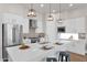 Bright kitchen boasts a large island, quartz countertops, stainless steel appliances, and contemporary pendant lighting at 1111 E Missouri Ave # 9, Phoenix, AZ 85014