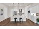 Modern kitchen featuring white cabinetry, a large island with bar seating, stainless steel appliances, and stylish pendant lighting at 1111 E Missouri Ave # 9, Phoenix, AZ 85014