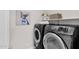 Laundry room with a front-load washer and dryer, shelving, and decor at 1111 E Missouri Ave # 9, Phoenix, AZ 85014