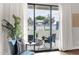 Living room view onto a private patio, framed by sheer curtains and featuring outdoor furniture and greenery at 1111 E Missouri Ave # 9, Phoenix, AZ 85014