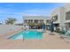 Community pool with lounge chairs, umbrellas, and modern building in the background at 1111 E Missouri Ave # 9, Phoenix, AZ 85014