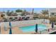 View of the community pool area with lounge seating, umbrellas, and a covered parking structure at 1111 E Missouri Ave # 9, Phoenix, AZ 85014