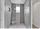 Modern walk-in shower with sleek tile, glass door, and convenient shower niche at 1111 E Missouri Ave # 9, Phoenix, AZ 85014