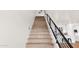 Elegant staircase featuring hardwood steps, modern black railing, and seamless transition to the open-concept living area at 1111 E Missouri Ave # 9, Phoenix, AZ 85014