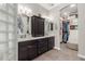 Elegant bathroom featuring double sinks, dark wood cabinetry, and a spacious walk-in closet at 11123 E Olla Ave, Mesa, AZ 85212
