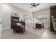 Stylish bedroom featuring a comfortable bed, dark wood furniture, ceiling fan and shuttered window at 11123 E Olla Ave, Mesa, AZ 85212