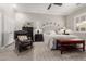 Cozy bedroom with a ceiling fan, area rug, and a comfortable leather chair and bench at 11123 E Olla Ave, Mesa, AZ 85212