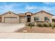 Charming single-story home with a three-car garage and a cozy front patio with desert landscaping at 11123 E Olla Ave, Mesa, AZ 85212