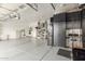 Spacious three car garage with epoxy floors, overhead storage, and built-in cabinets at 11123 E Olla Ave, Mesa, AZ 85212