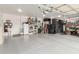 Large, organized garage with ample storage, bright lighting, and clean epoxy flooring at 11123 E Olla Ave, Mesa, AZ 85212