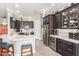 Modern kitchen with dark cabinets, white countertops, stainless steel appliances, and bar seating at 11123 E Olla Ave, Mesa, AZ 85212